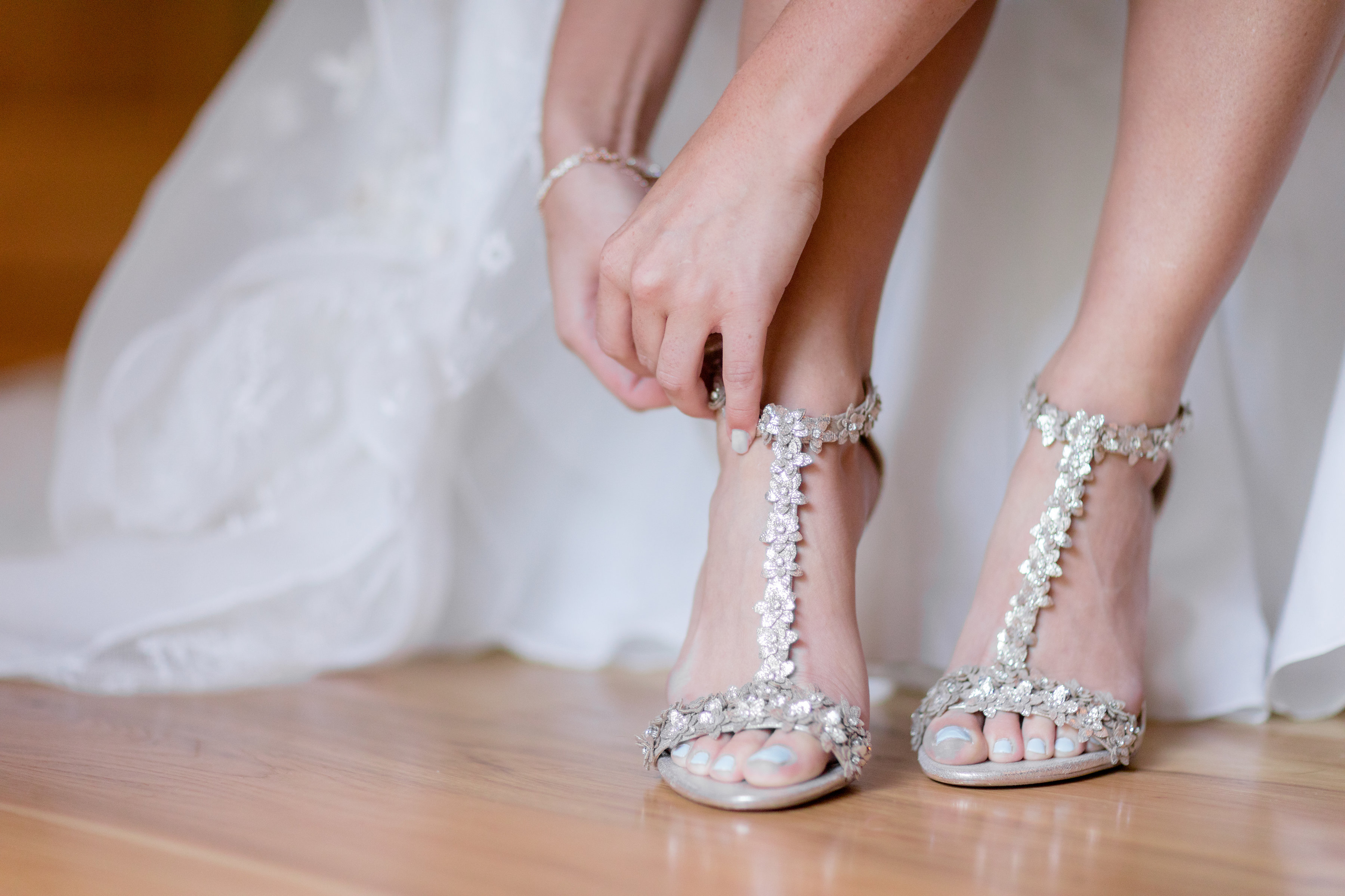 putting wedding shoes on 