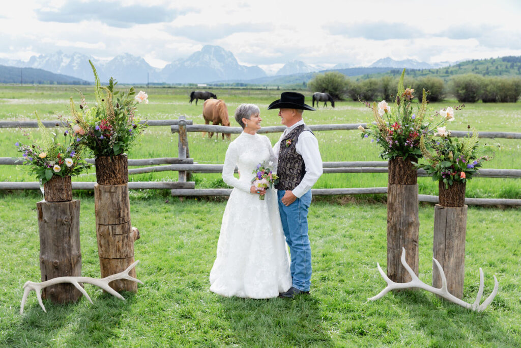 A wedding ceremony site with logs, flowers, and antlers in front of Mount Moran at Diamond Cross Ranch in Jackson Hole | Jamye Chrisman | Wyoming Wedding Photographer