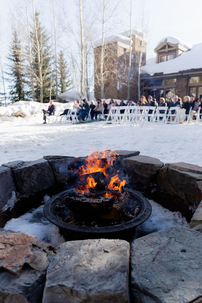 Winter weddings at the Four Seasons in Jackson Hole include a firepit for gathering and warm guests | Jamye Chrisman | Jackson Hole Wedding Photographer