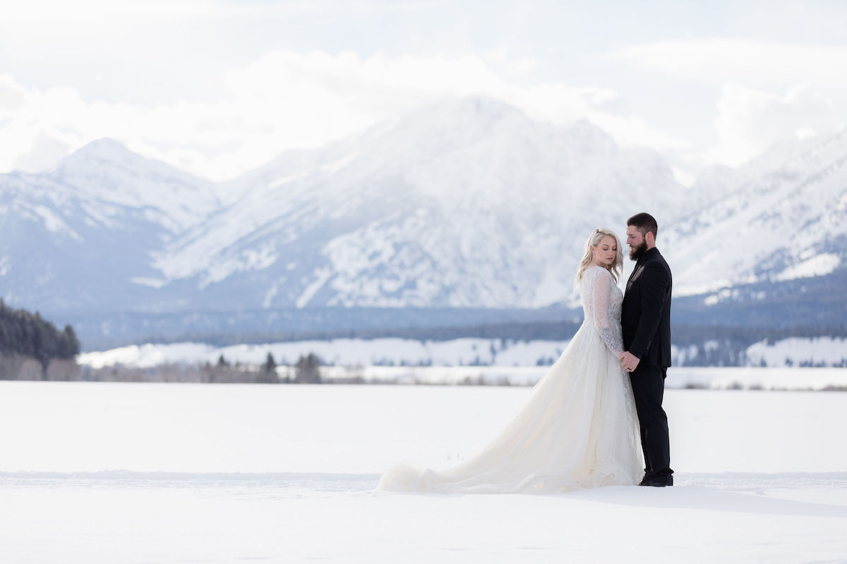 A couple poses in Grand Teton National Park during their winter wedding photoshoot | Jamye Chrisman | Jackson Hole Wedding Photographer