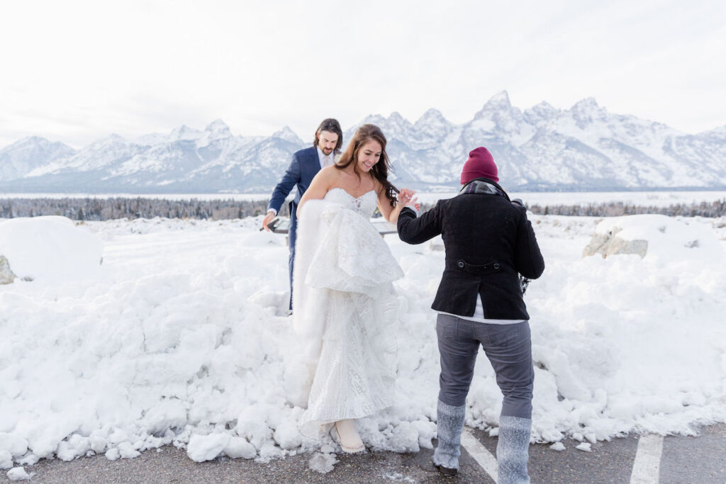 A bride walks over a snowbank during her winter wedding photoshoot in the Tetons | Jamye Chrisman | Jackson Hole Wedding Photographer