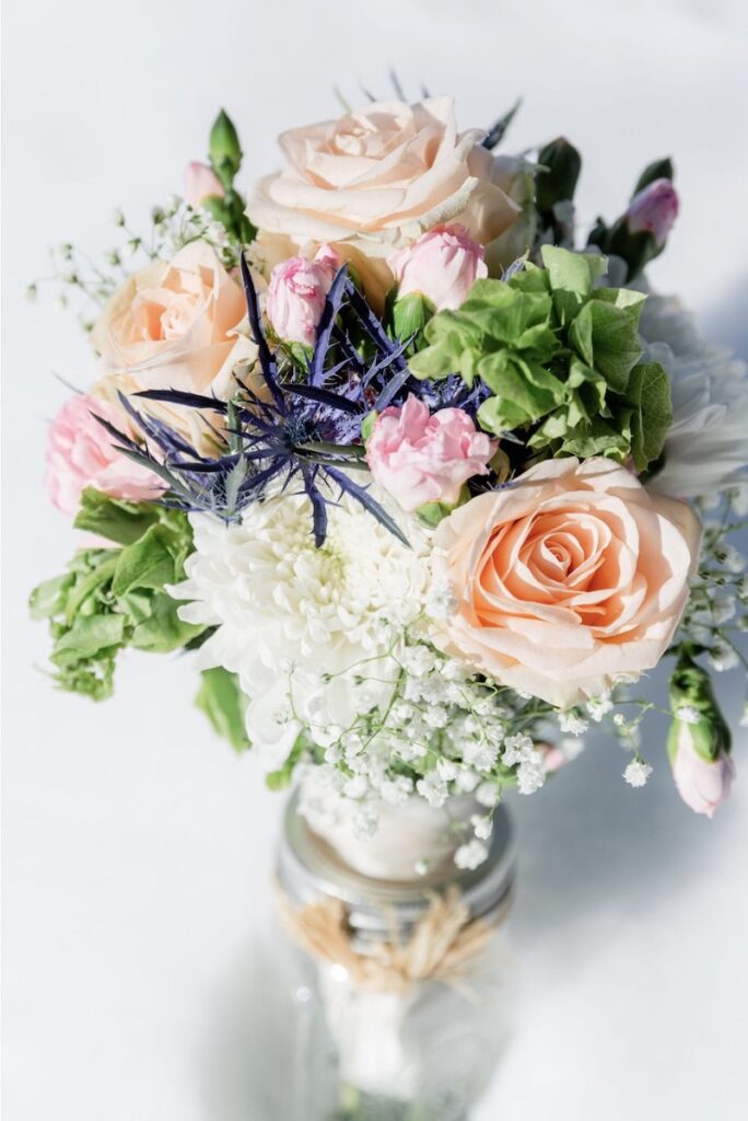 A winter wedding bouquet including blush, pink, purple, and green | Jamye Chrisman | Jackson Hole Wedding Photographer