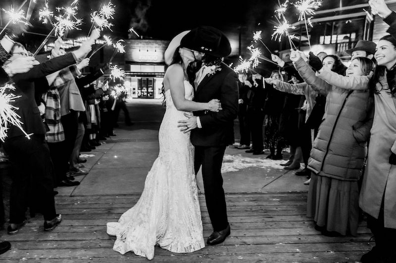 A couple kisses during their winter wedding reception in Jackson Hole Wyoming