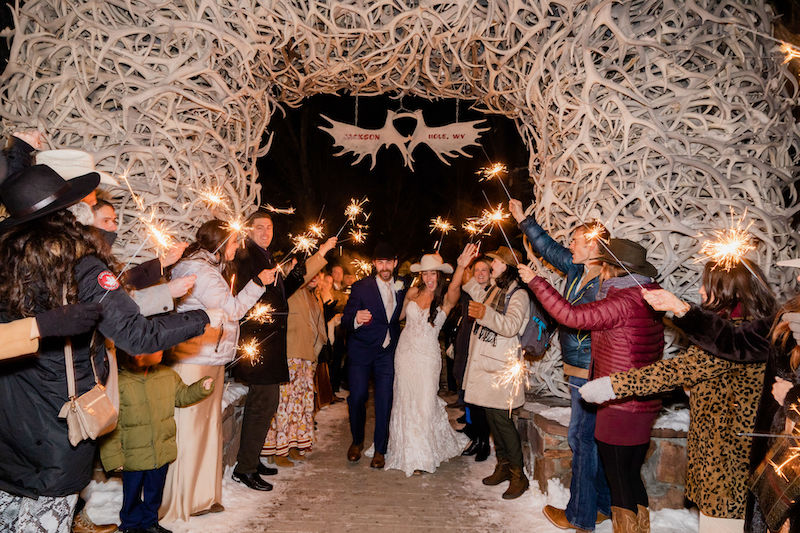 A sparkler send-off under the elk antler arches in Jackson Hole in the winter | Jamye Chrisman Photography