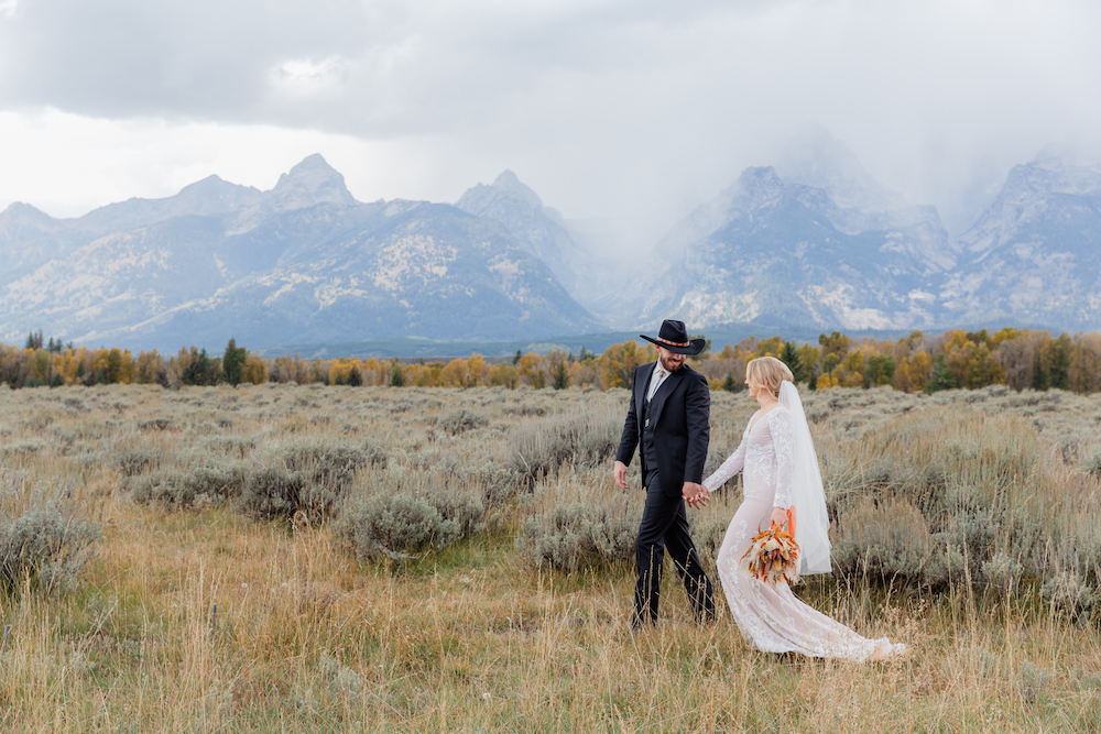 A just-married couple walks in Grand Teton National Park after a rain storm | Jackson Hole Wedding Photographer Jamye Chrisman