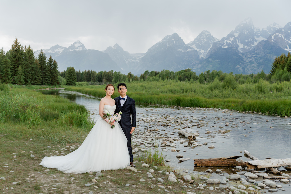 An intimate vow ceremony in stormy skies at Schwabacher Landing in Grand Teton National Park | Jamye Chrisman Photography