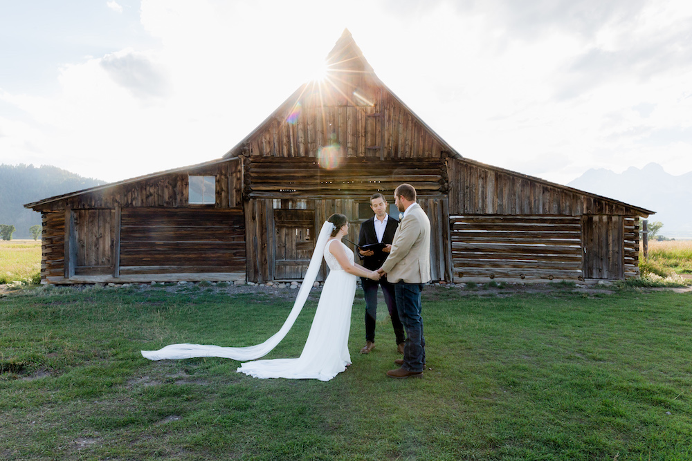 A private wedding ceremony in front of a barn in Grand Teton National Park