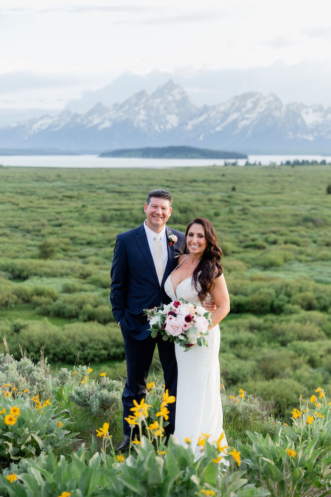 A wedding photoshoot at Jackson Lake Lodge includes mountain views and wildflowers